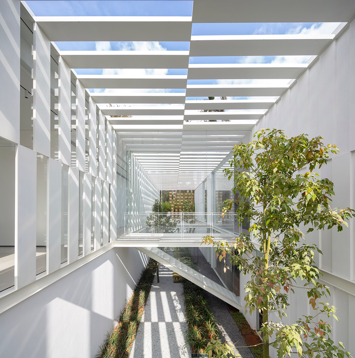 Large sunken yard defines the program of Split House designed by Pitsou Kedem Architects in Israel