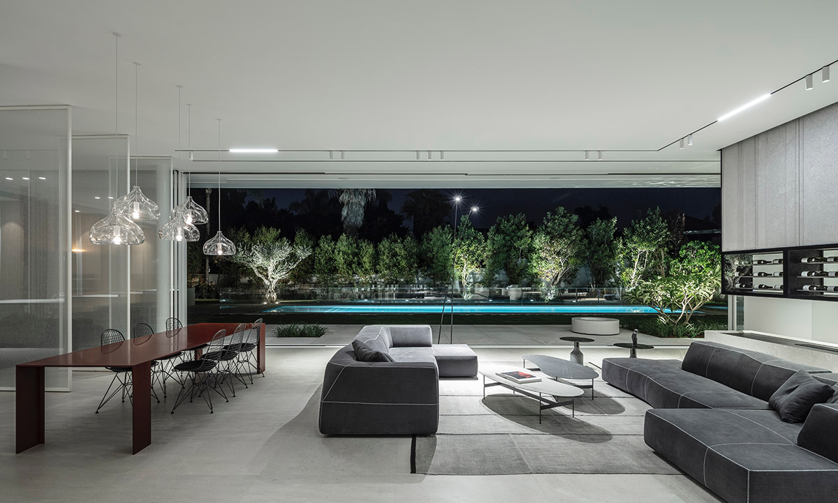 Large sunken yard defines the program of Split House designed by Pitsou Kedem Architects in Israel