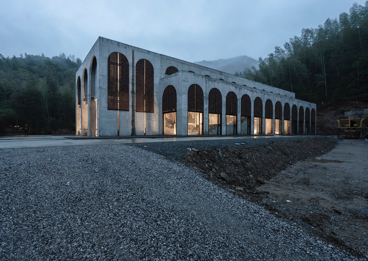 AZL Architects renovates old kiln building with concrete and brick arches in the middle of a forest