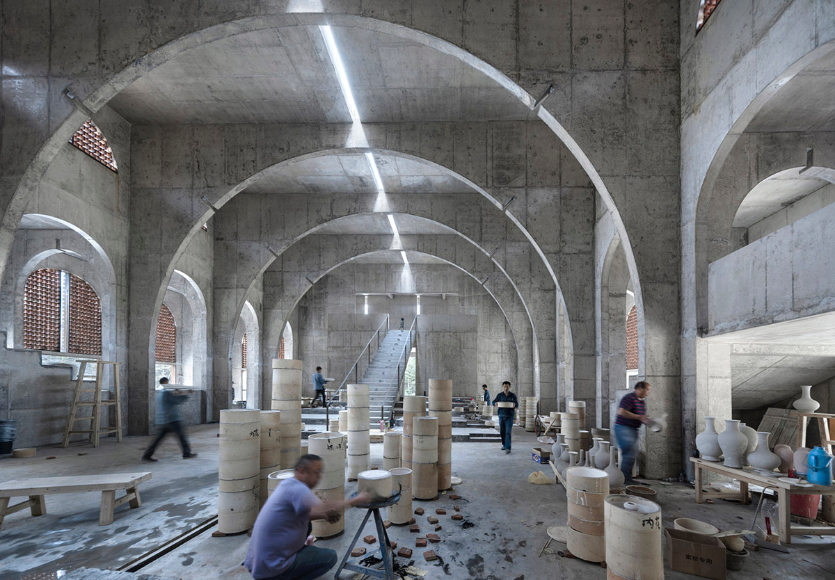 AZL Architects renovates old kiln building with concrete and brick arches in the middle of a forest