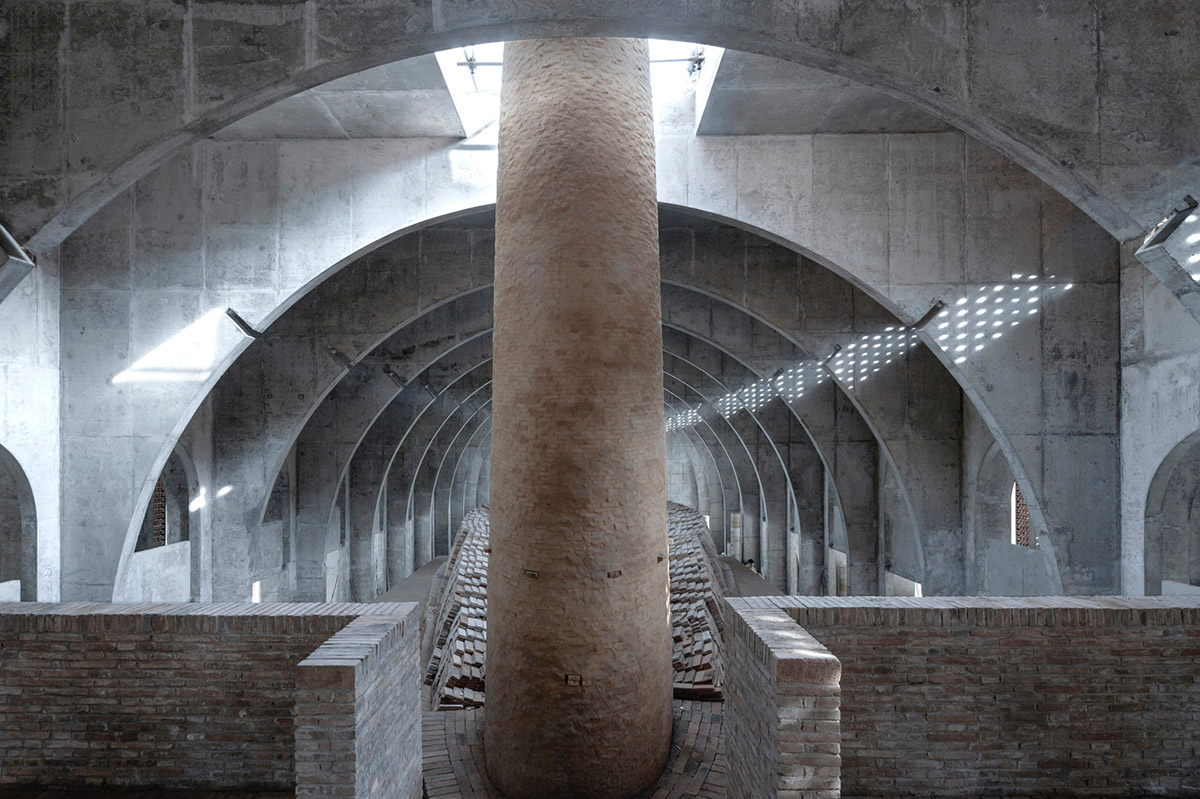 AZL Architects renovates old kiln building with concrete and brick arches in the middle of a forest