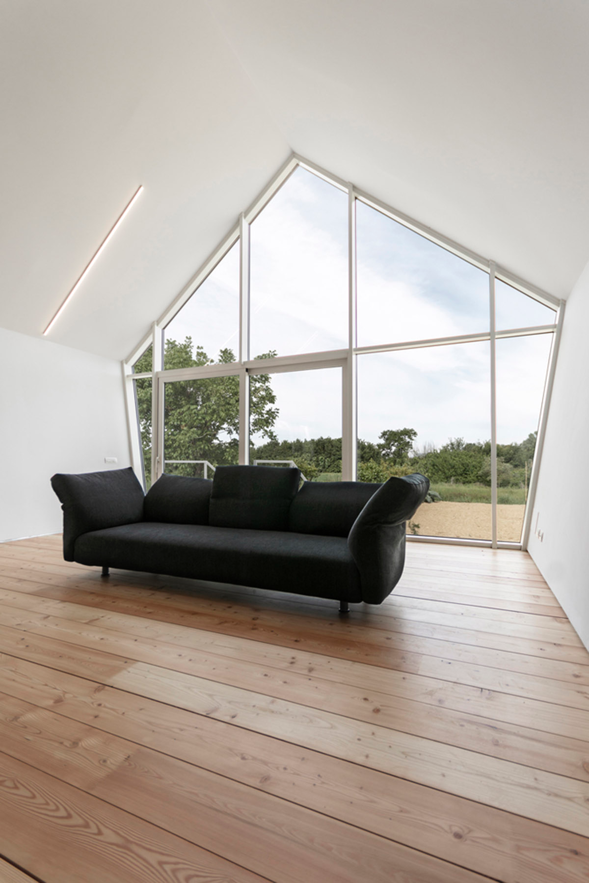 LDA.iMdA architetti associati built modular house raised on stilts in the middle of orchard in Italy