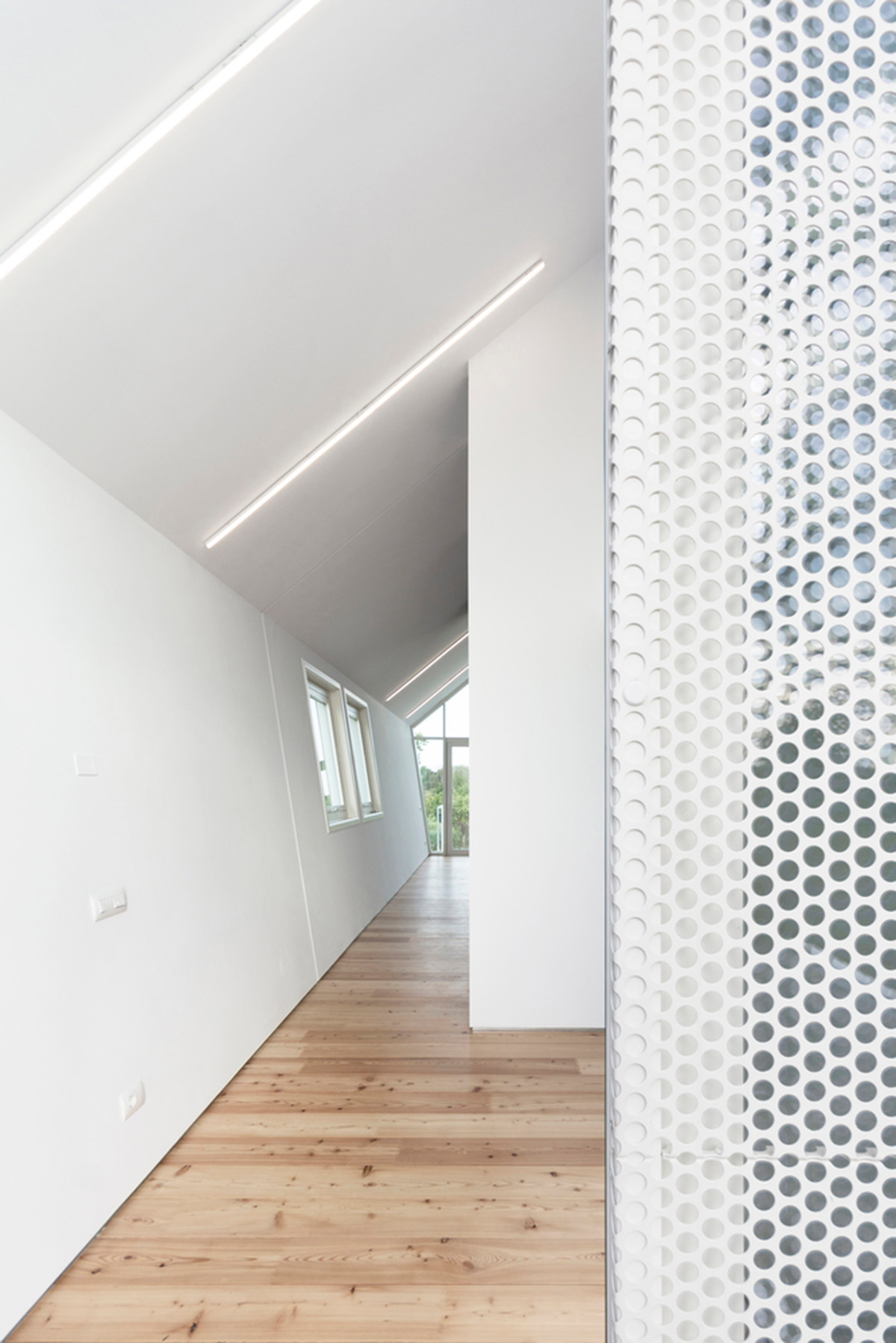 LDA.iMdA architetti associati built modular house raised on stilts in the middle of orchard in Italy