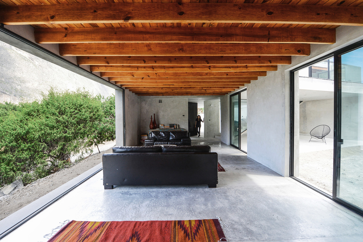 P+0 Arquitectura designs residence mixed with concrete and stone volumes on a complex terrain