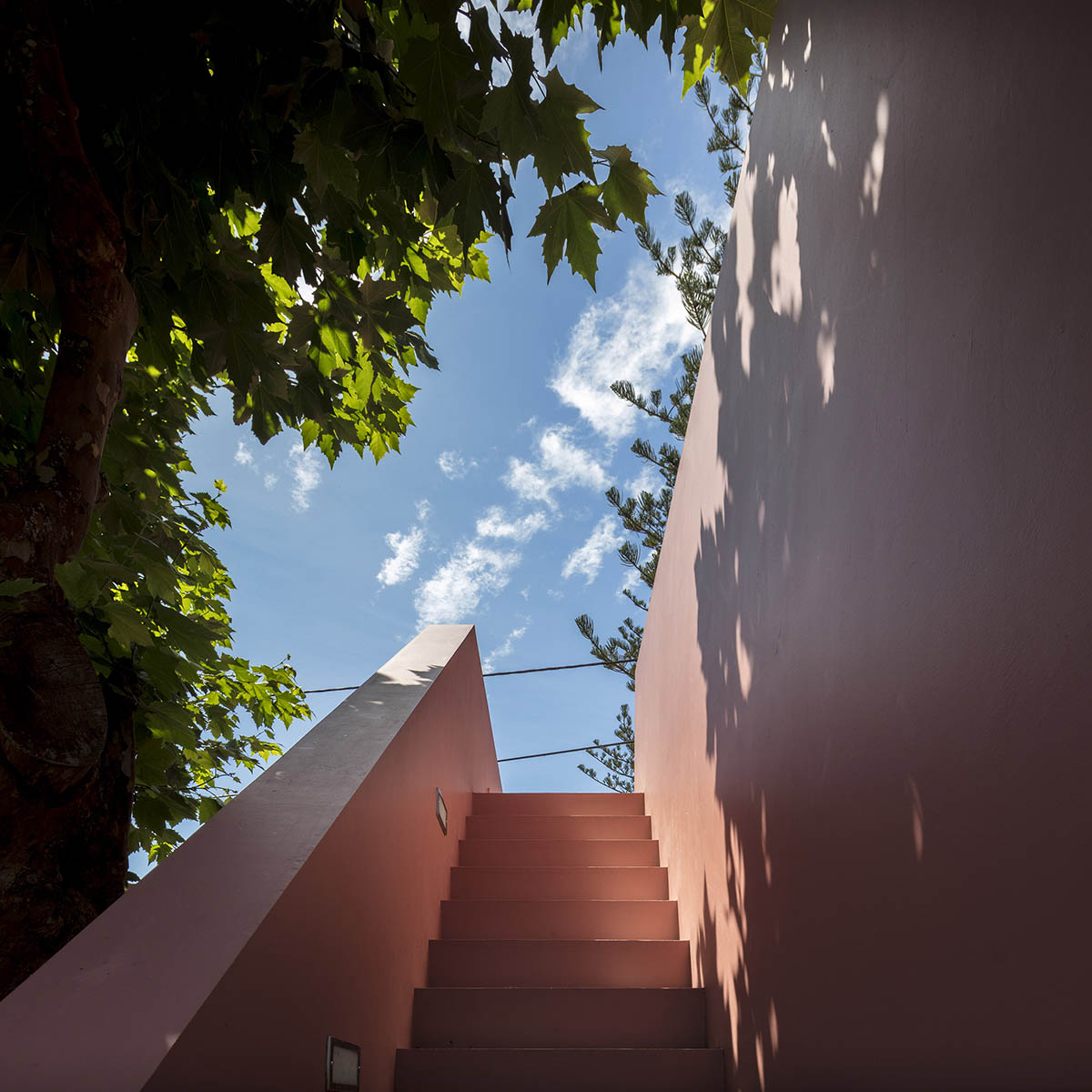 Mezzo Atelier transforms old barn into guesthouses featuring different hues of pink