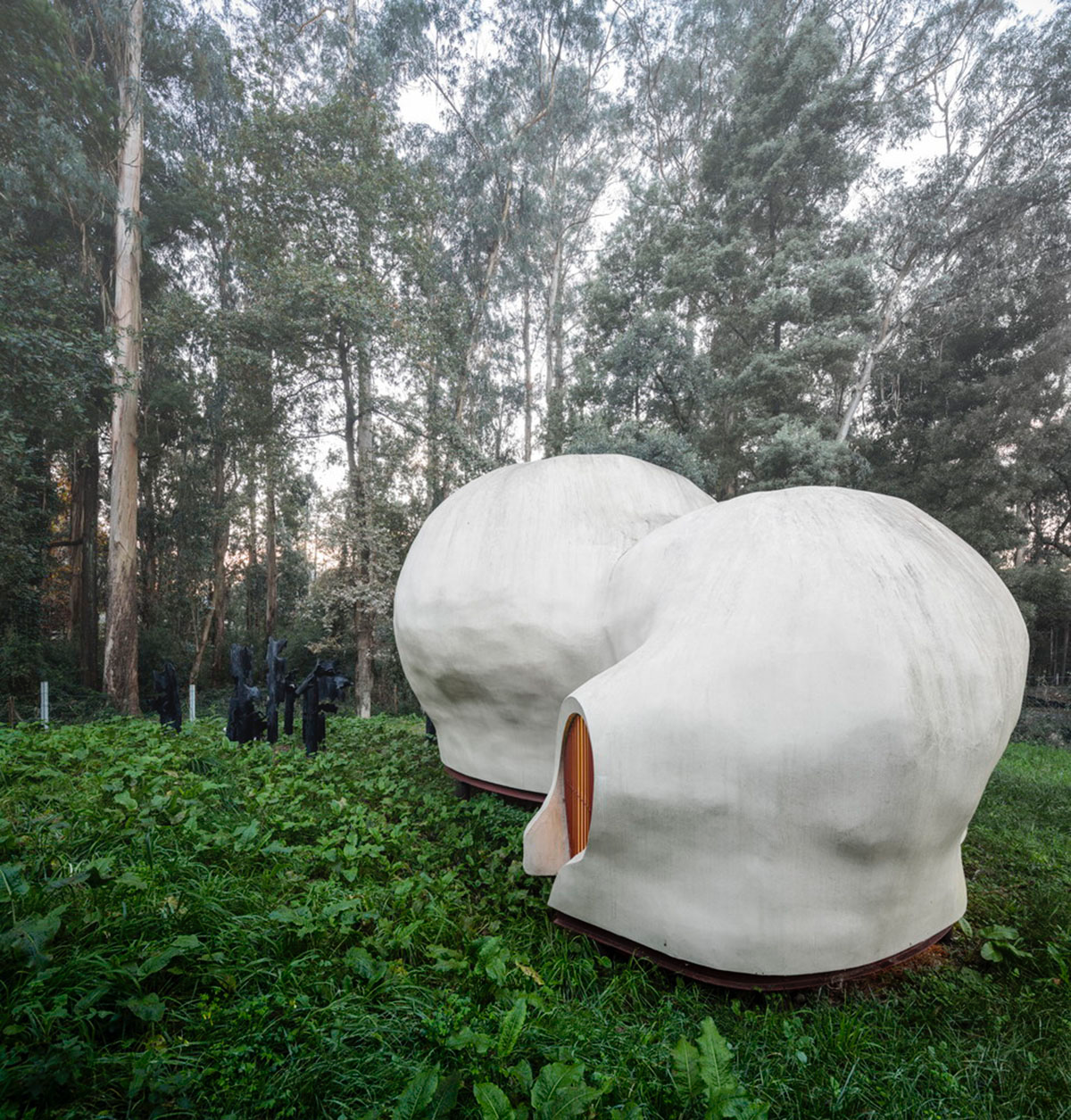 Super small cave-like art gallery by FCC Arquitectura built on lush green in Portugal