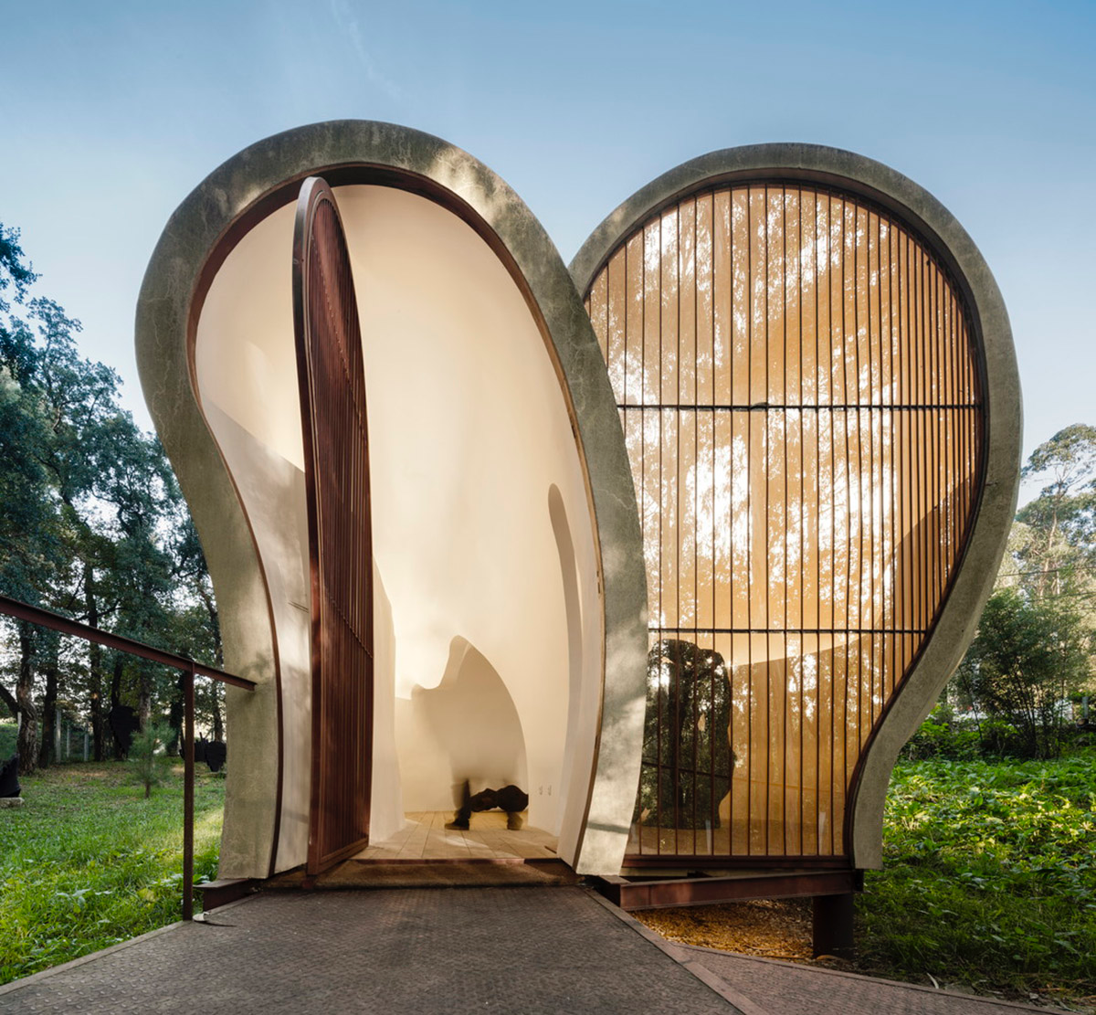 Super small cave-like art gallery by FCC Arquitectura built on lush green in Portugal