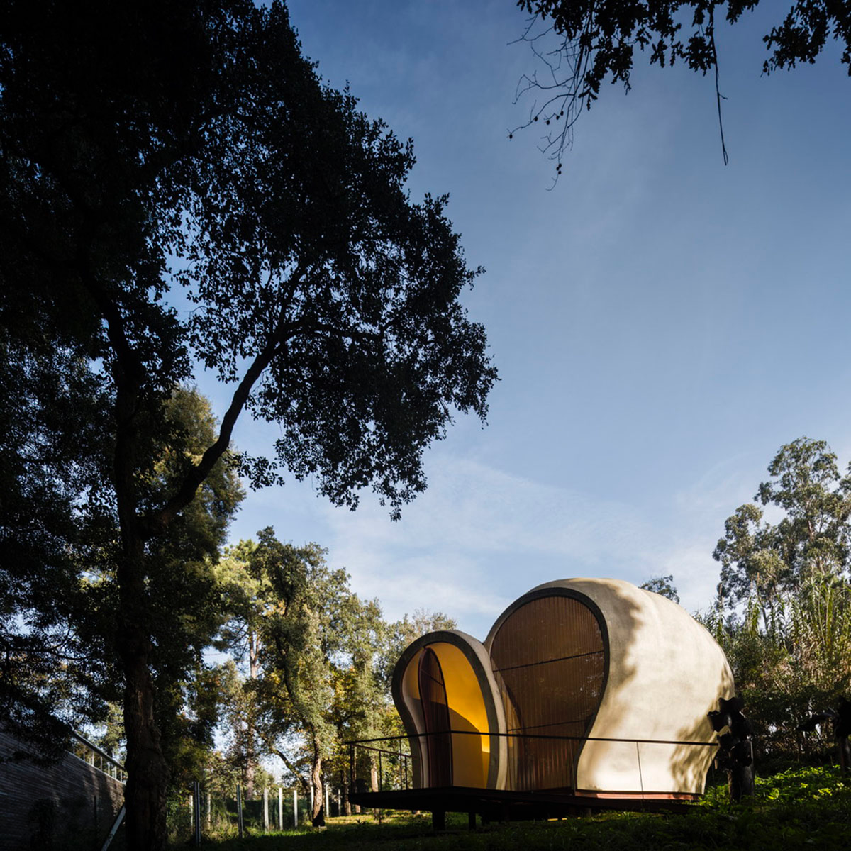 Super small cave-like art gallery by FCC Arquitectura built on lush green in Portugal