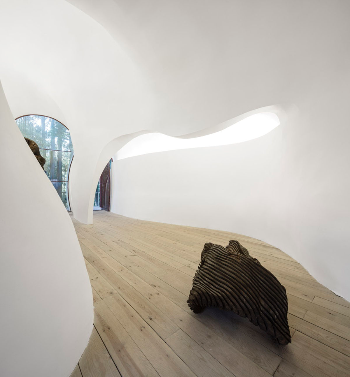 Super small cave-like art gallery by FCC Arquitectura built on lush green in Portugal
