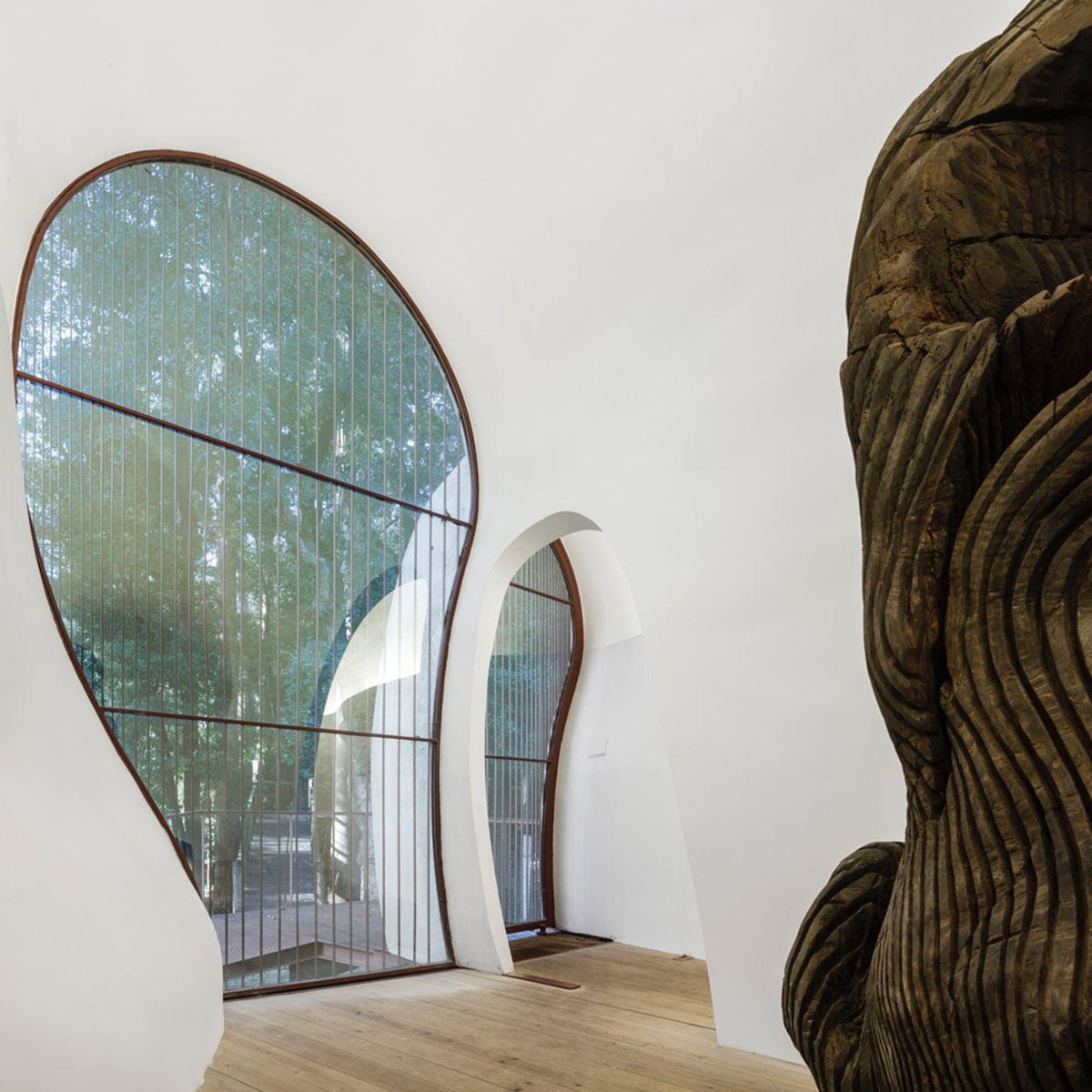 Super small cave-like art gallery by FCC Arquitectura built on lush green in Portugal