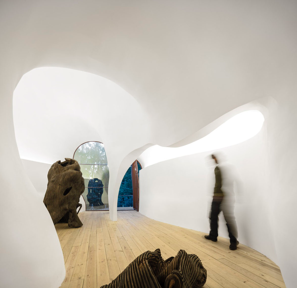 Super small cave-like art gallery by FCC Arquitectura built on lush green in Portugal