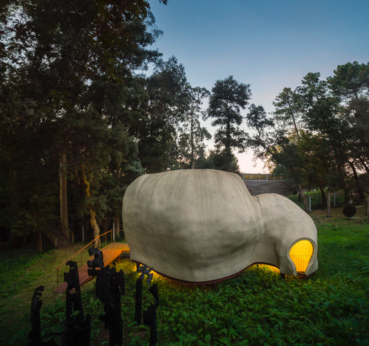 Super small cave-like art gallery by FCC Arquitectura built on lush green in Portugal