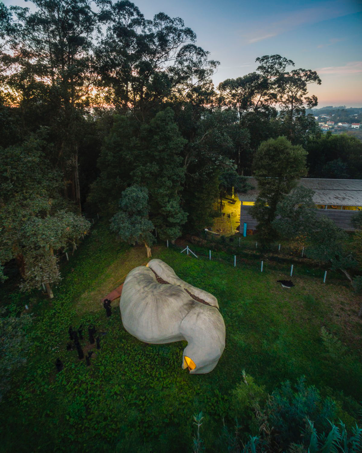 Super small cave-like art gallery by FCC Arquitectura built on lush green in Portugal