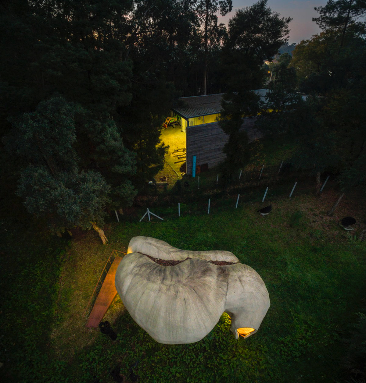 Super small cave-like art gallery by FCC Arquitectura built on lush green in Portugal