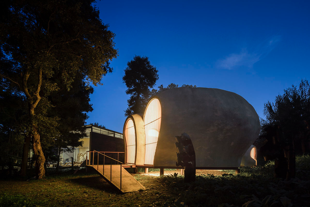 Super small cave-like art gallery by FCC Arquitectura built on lush green in Portugal