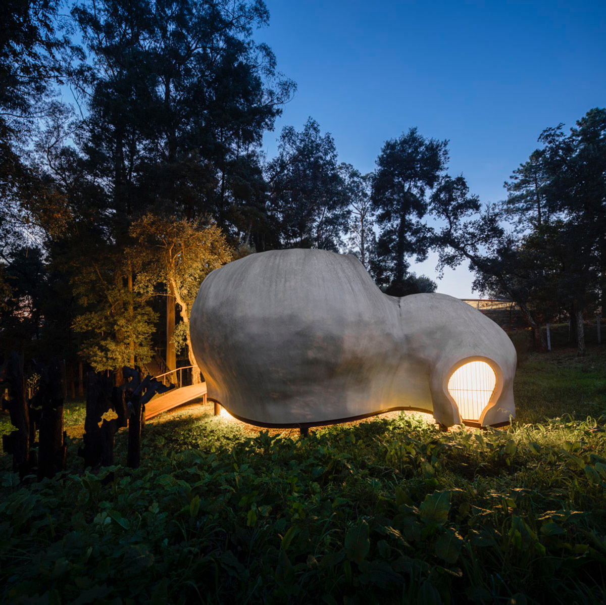 Super small cave-like art gallery by FCC Arquitectura built on lush green in Portugal