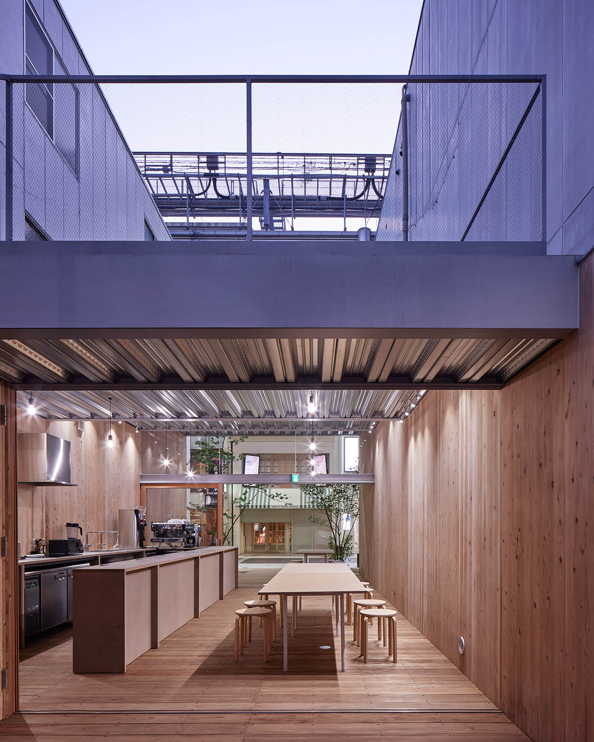 Yabashi Architects built this stepped and simple wooden boxed-cafe in a narrow site in Kyushu