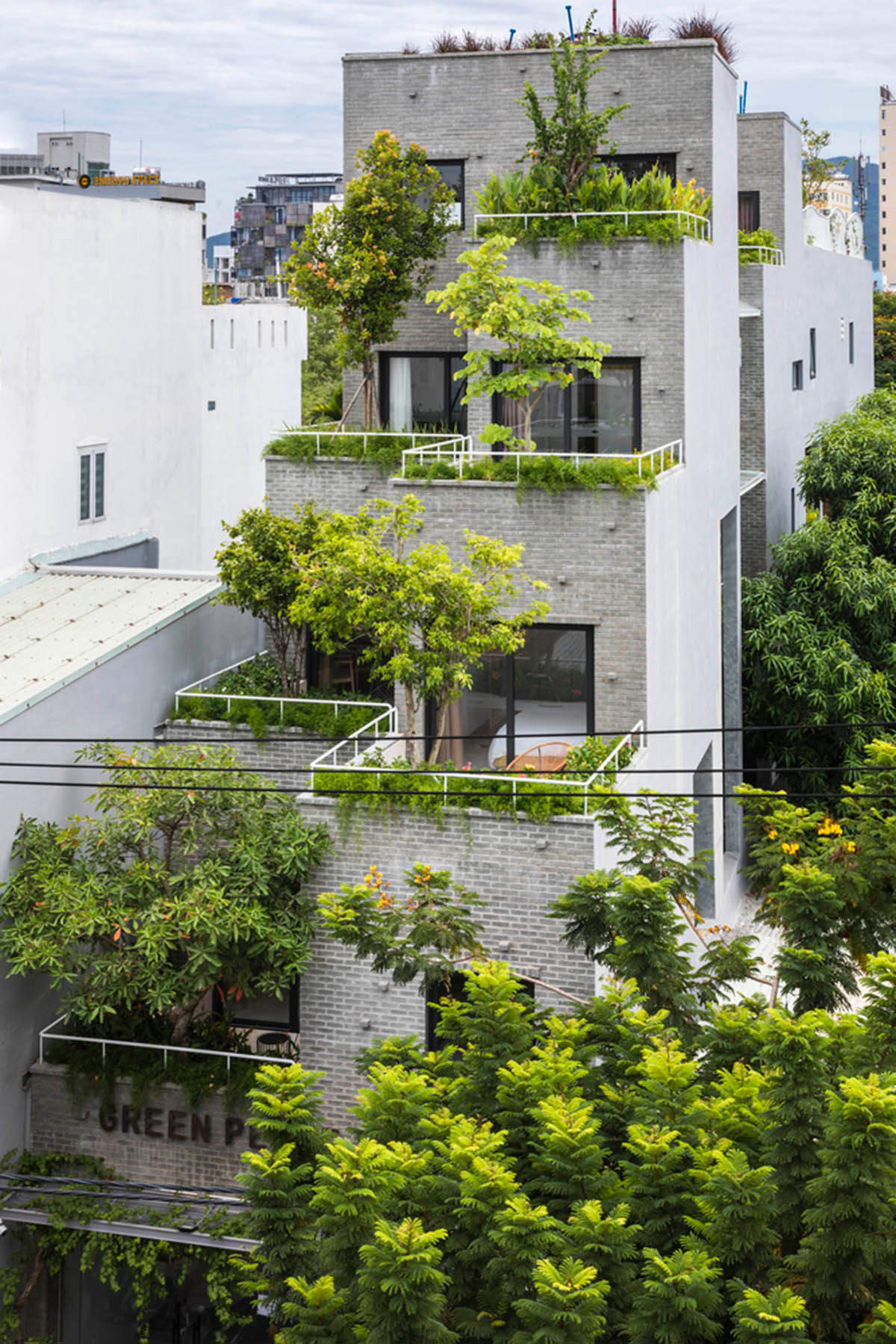 Ho Khue Architects brings jungle life into a terraced apartment building in the Da Nang City, Vietnam