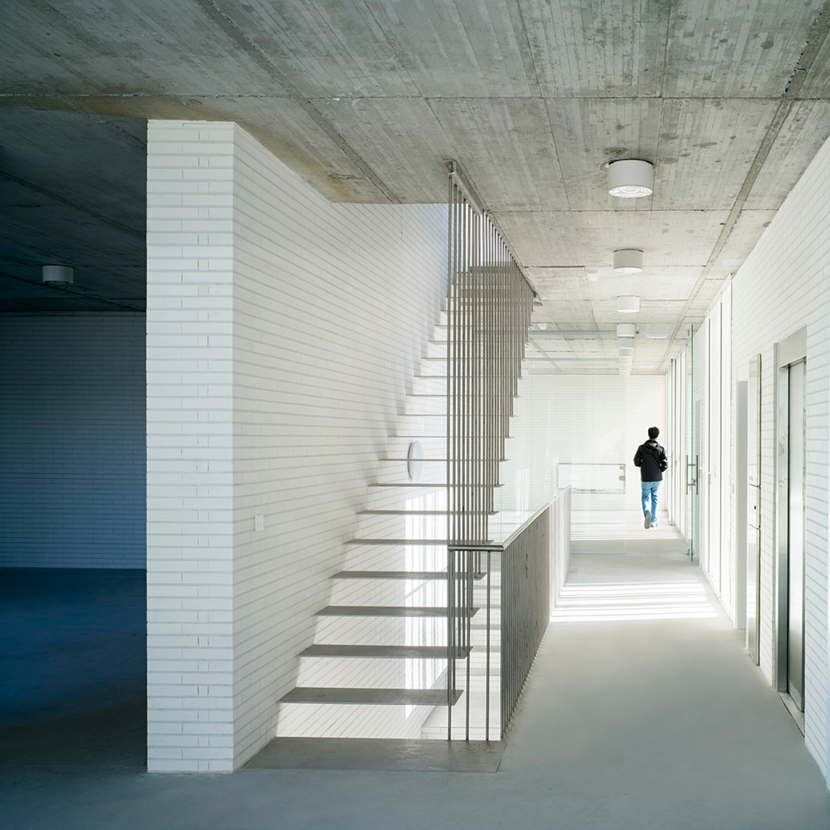 White cubic volumes combined with inward system of patios to create zero-energy Port Operations HQ