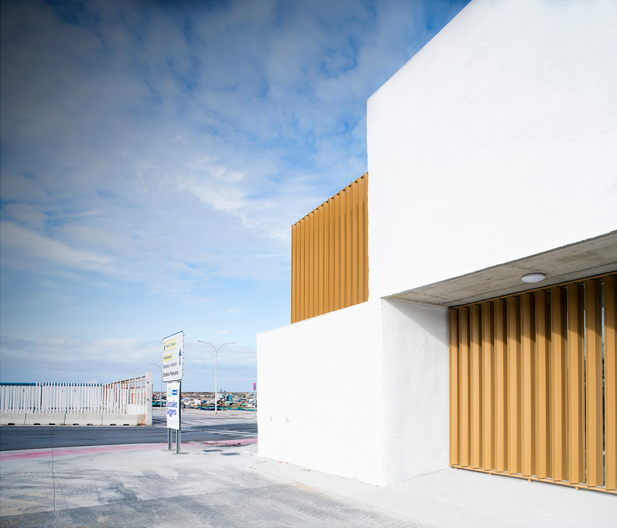 White cubic volumes combined with inward system of patios to create zero-energy Port Operations HQ