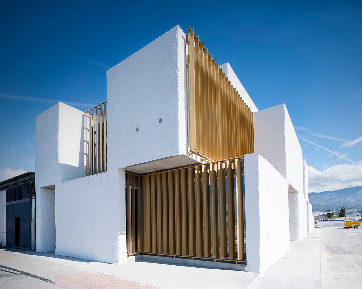 White cubic volumes combined with inward system of patios to create zero-energy Port Operations HQ