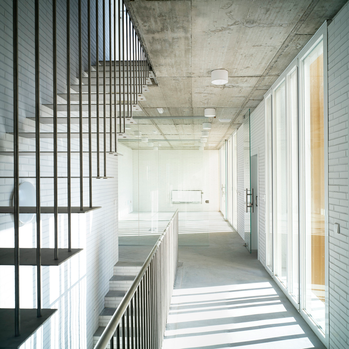 White cubic volumes combined with inward system of patios to create zero-energy Port Operations HQ