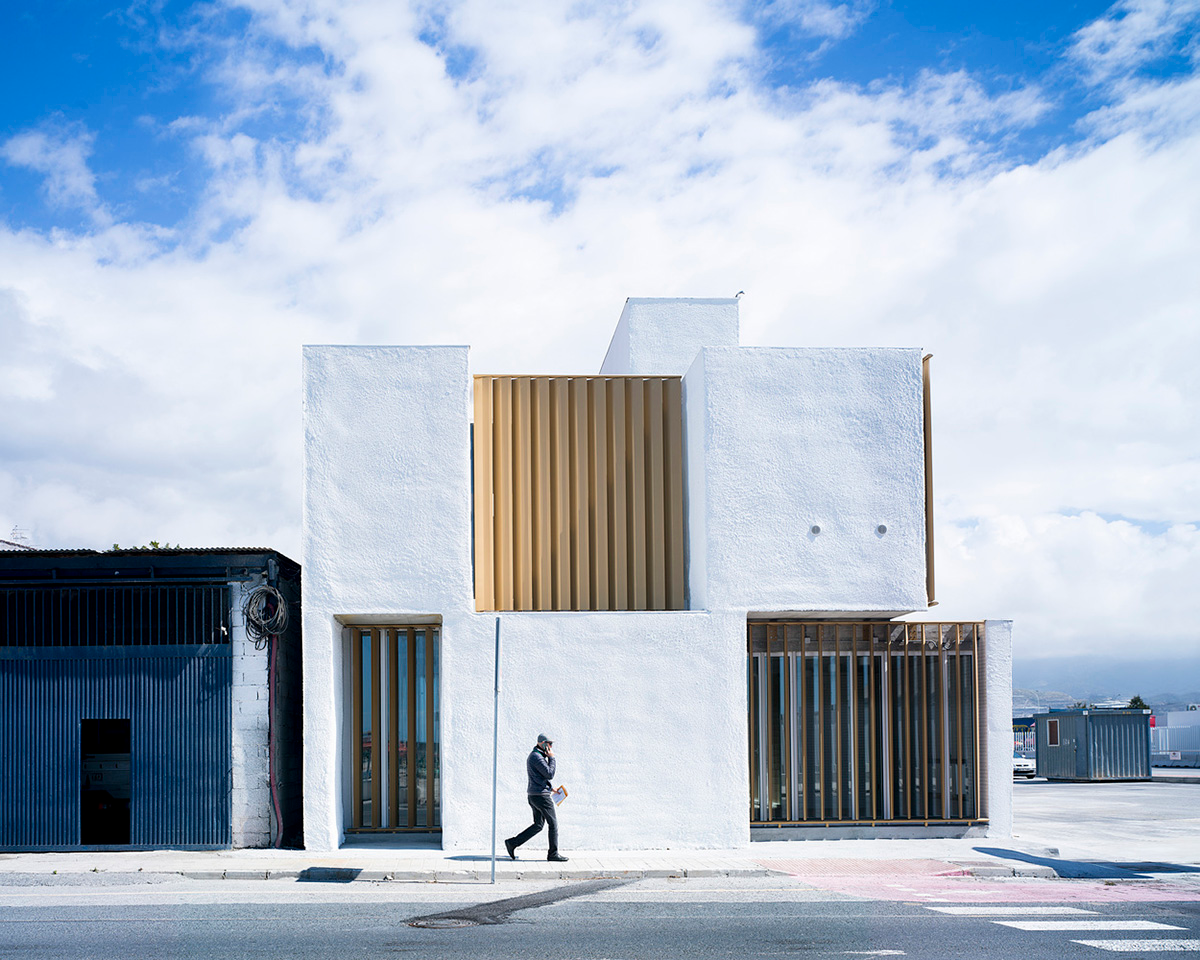 White cubic volumes combined with inward system of patios to create zero-energy Port Operations HQ