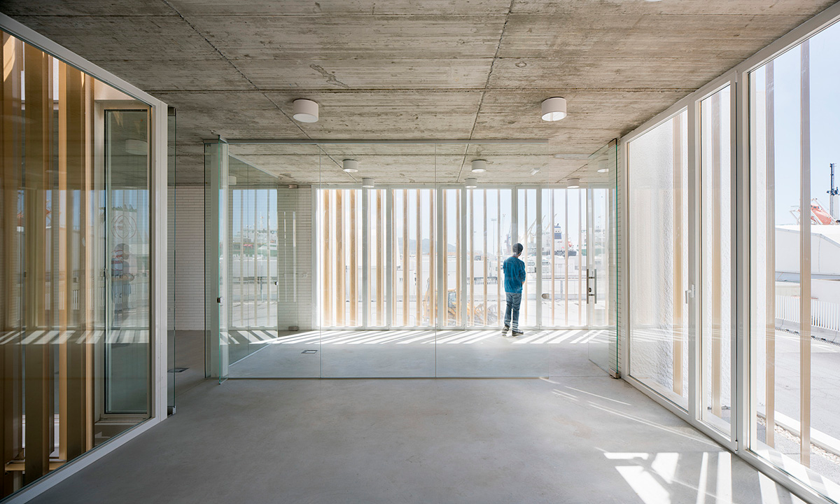 White cubic volumes combined with inward system of patios to create zero-energy Port Operations HQ