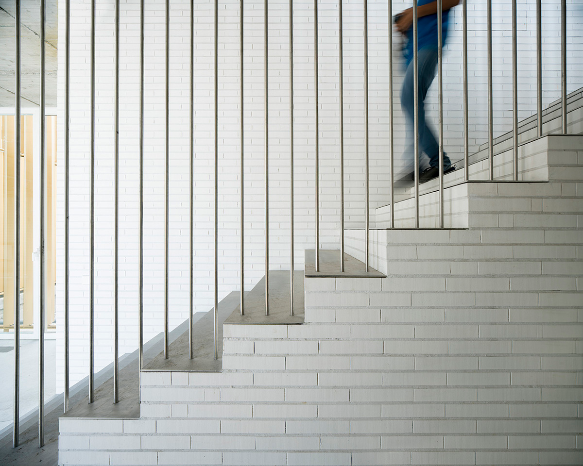 White cubic volumes combined with inward system of patios to create zero-energy Port Operations HQ