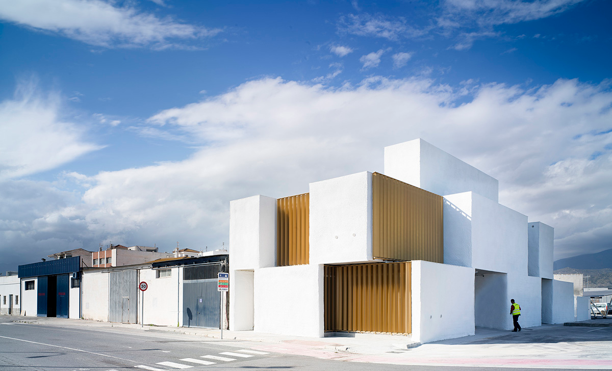 White cubic volumes combined with inward system of patios to create zero-energy Port Operations HQ