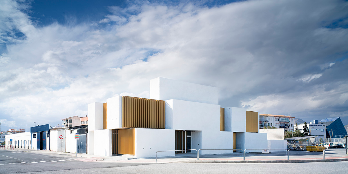 White cubic volumes combined with inward system of patios to create zero-energy Port Operations HQ
