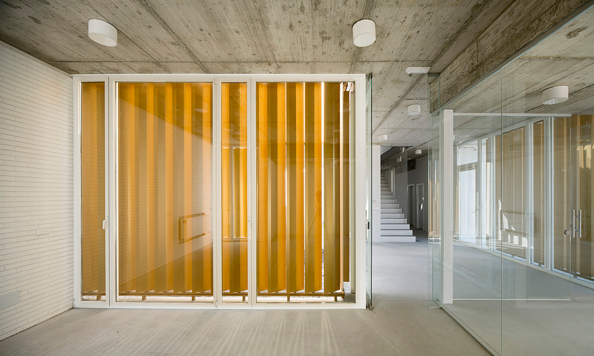 White cubic volumes combined with inward system of patios to create zero-energy Port Operations HQ