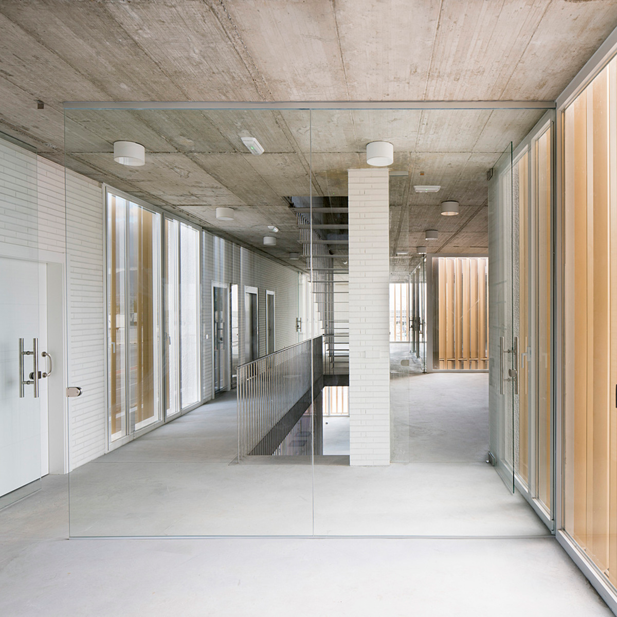 White cubic volumes combined with inward system of patios to create zero-energy Port Operations HQ