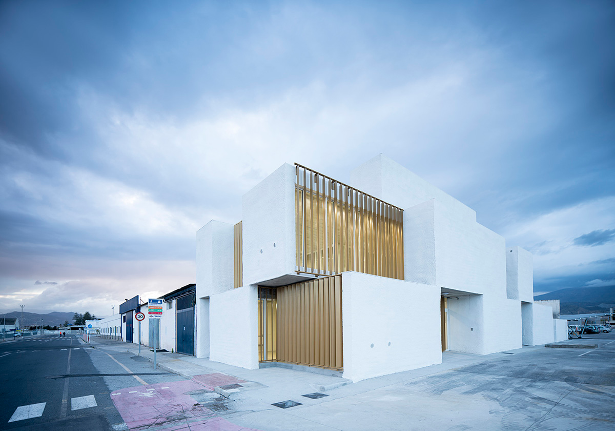 White cubic volumes combined with inward system of patios to create zero-energy Port Operations HQ