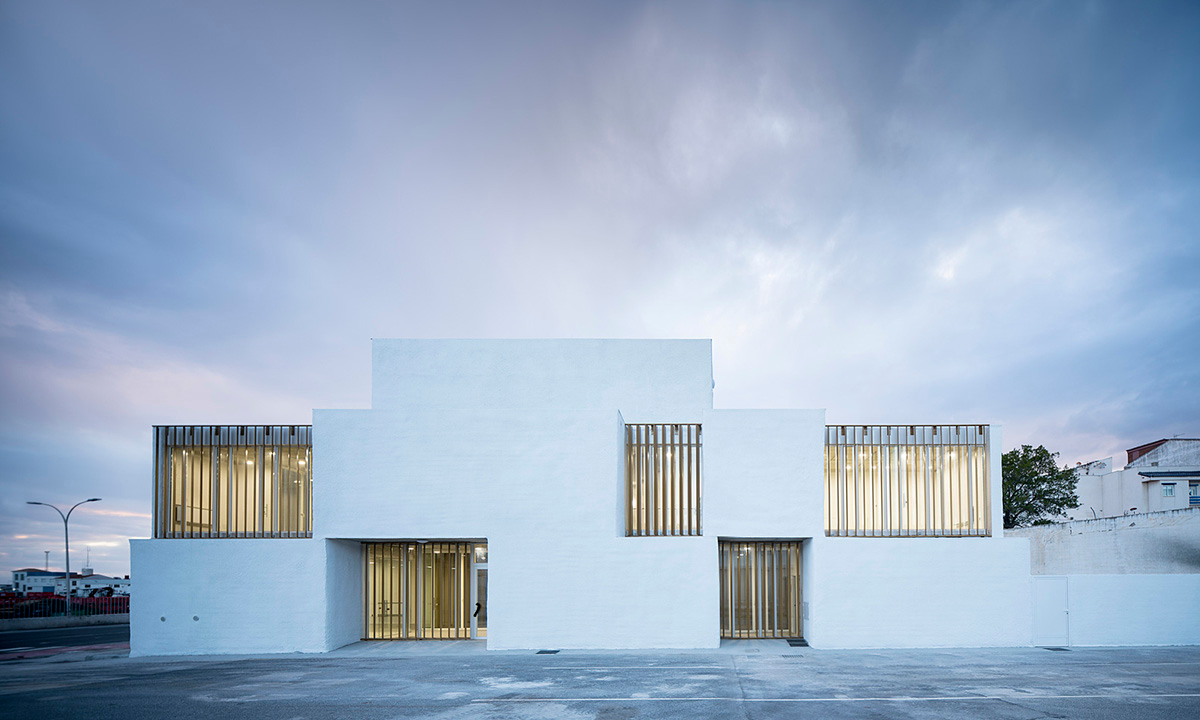 White cubic volumes combined with inward system of patios to create zero-energy Port Operations HQ