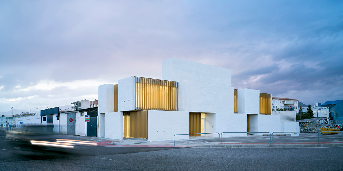 White cubic volumes combined with inward system of patios to create zero-energy Port Operations HQ