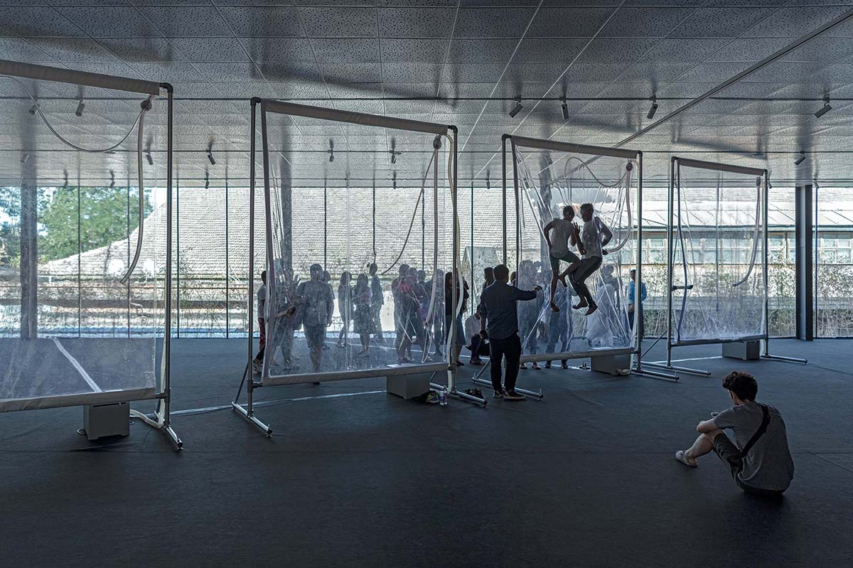 Archstudio converts old art gallery into a new art center with translucent metal curtains in Beijing
