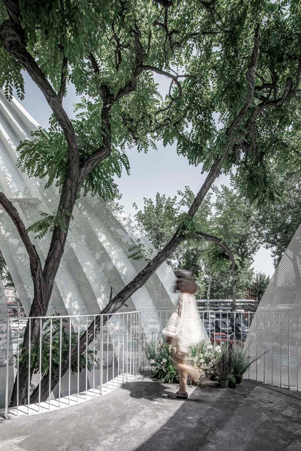 Archstudio converts old art gallery into a new art center with translucent metal curtains in Beijing