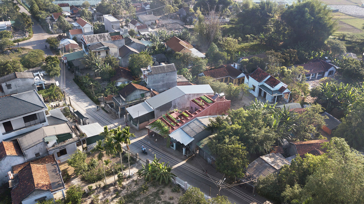 This reddish house features rooftop garden to make owners grow their own food in Vietnam