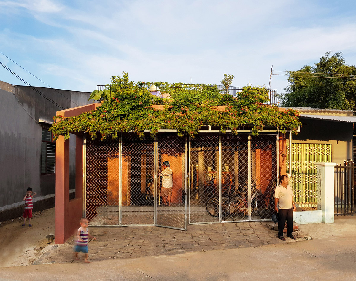 This reddish house features rooftop garden to make owners grow their own food in Vietnam