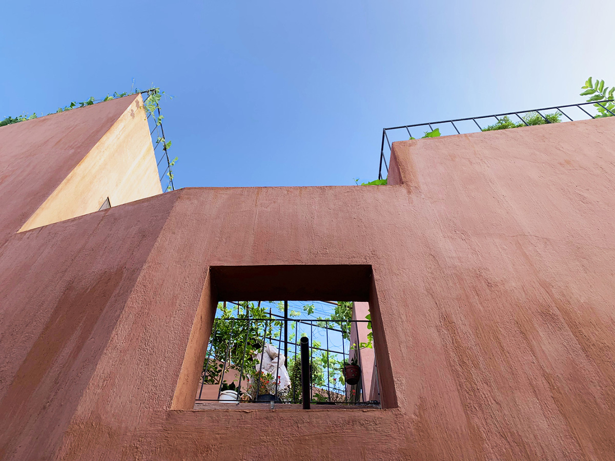 This reddish house features rooftop garden to make owners grow their own food in Vietnam