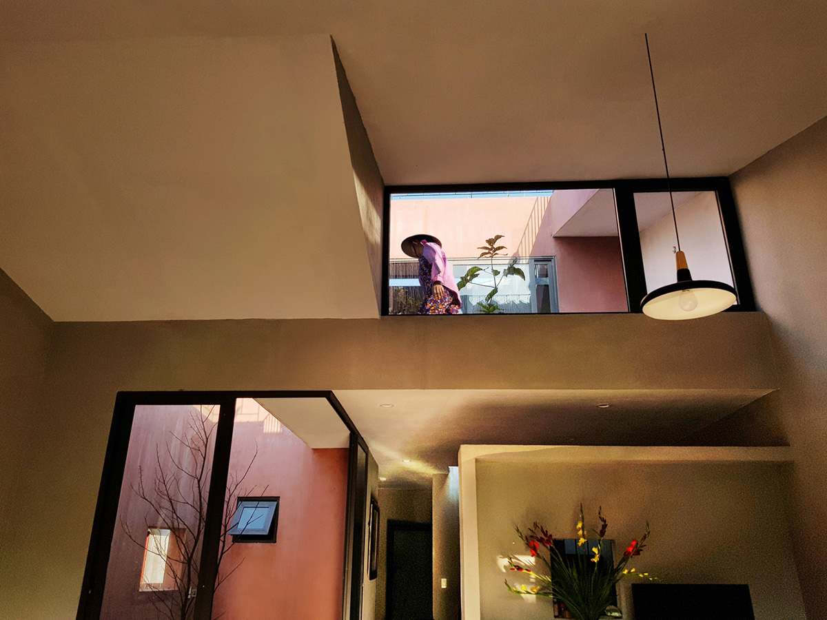 This reddish house features rooftop garden to make owners grow their own food in Vietnam