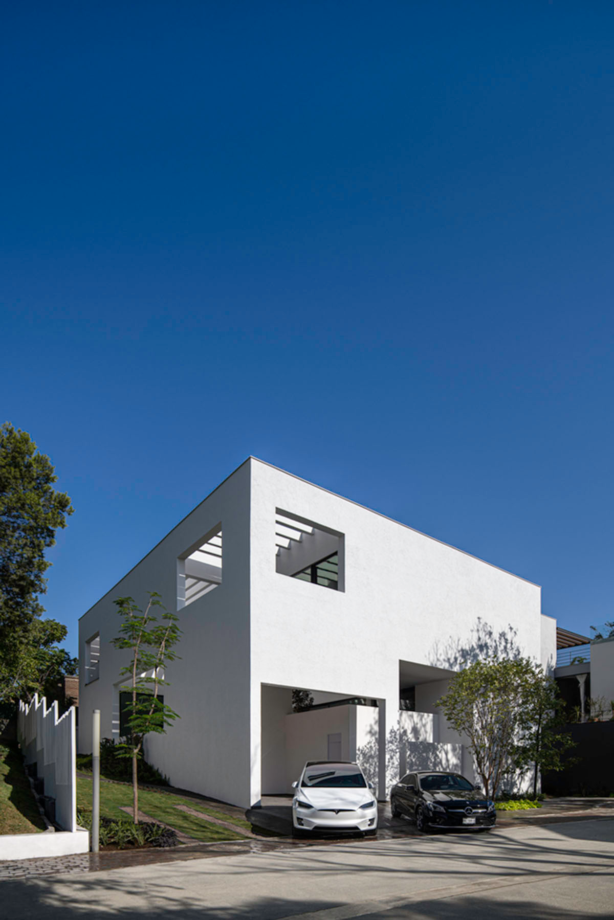 Cadaval & Solà-Morales' white excavated house features porous interior that expands activities