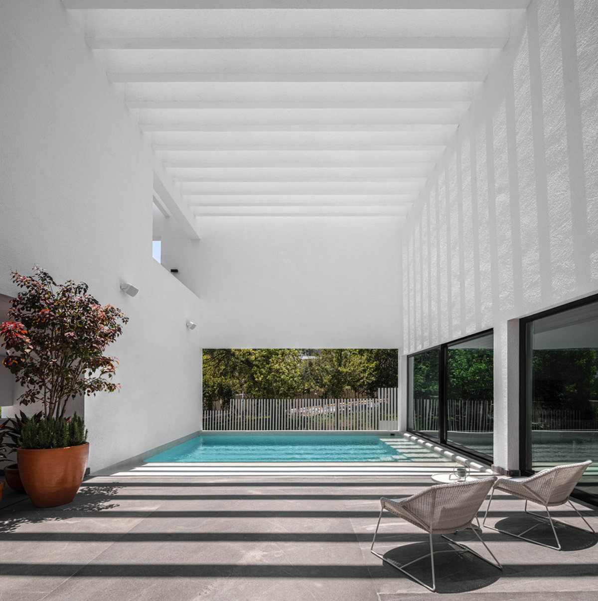 Cadaval & Solà-Morales' white excavated house features porous interior that expands activities