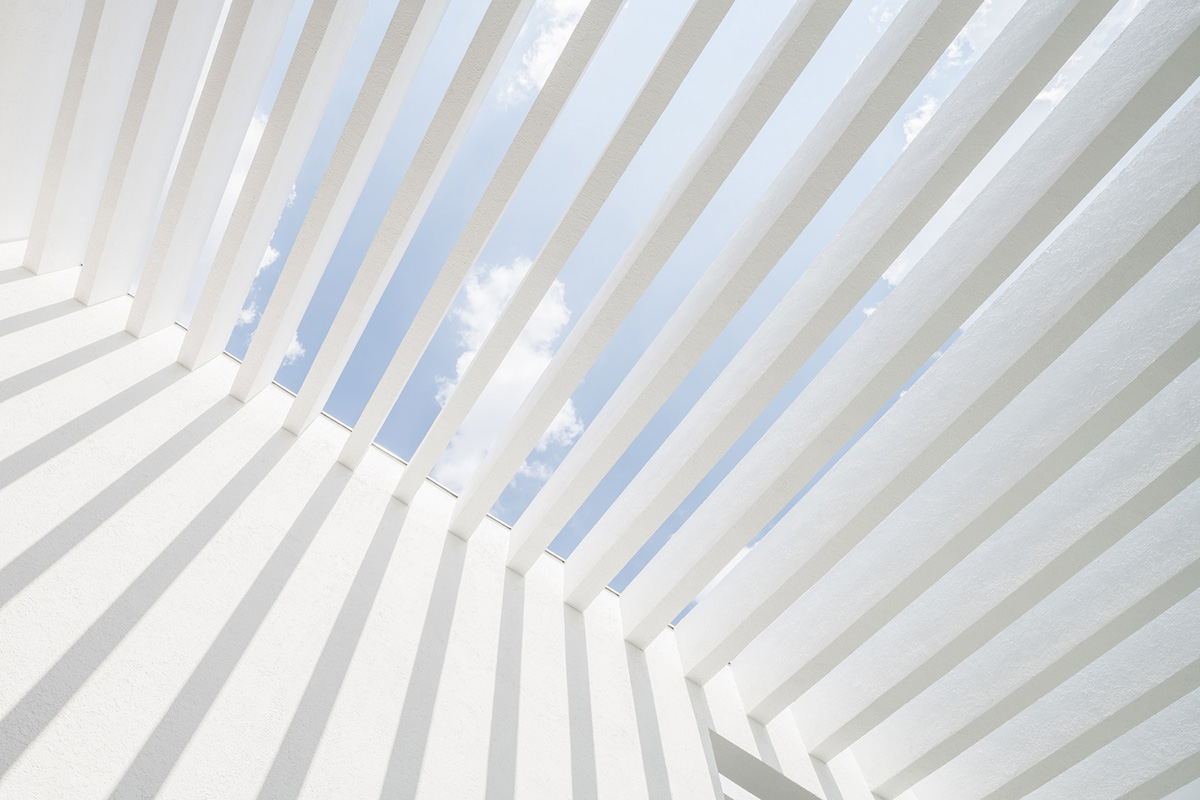 Cadaval & Solà-Morales' white excavated house features porous interior that expands activities