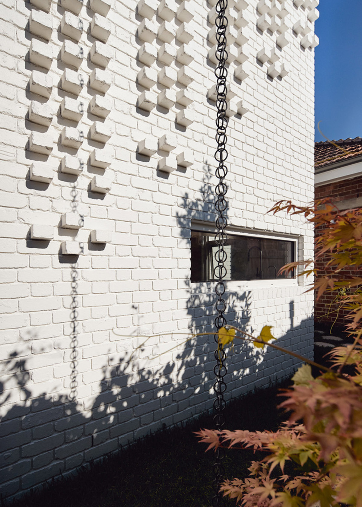 Atelier Red+Black built white Cascade House that features different patterns of brick in Melbourne