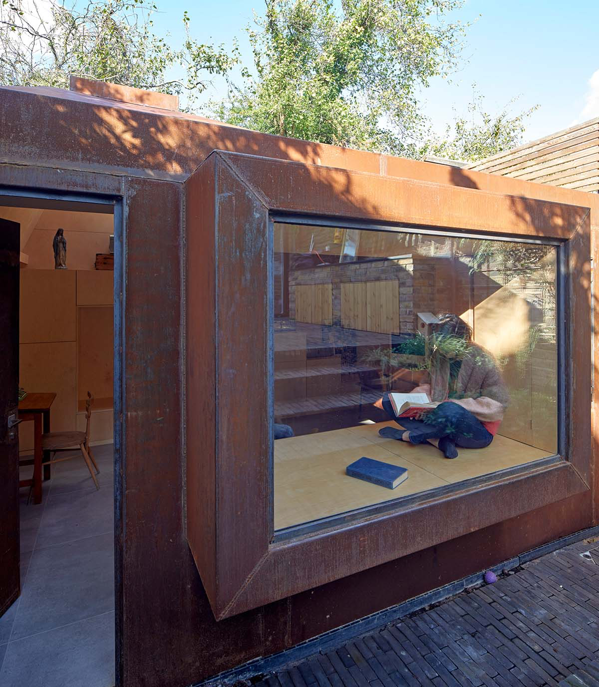 RISE Design Studio built sunken garden studio with rusted steel to provide a hidden place to escape