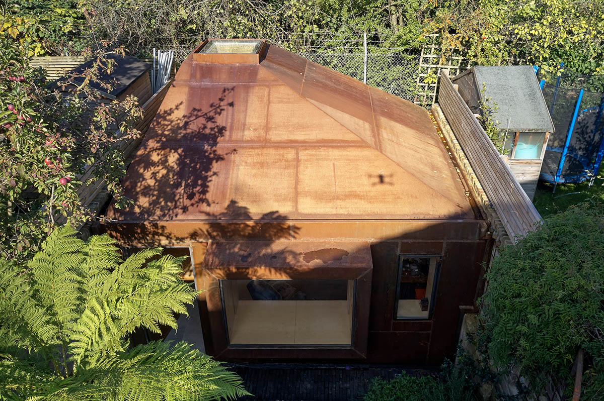RISE Design Studio built sunken garden studio with rusted steel to provide a hidden place to escape