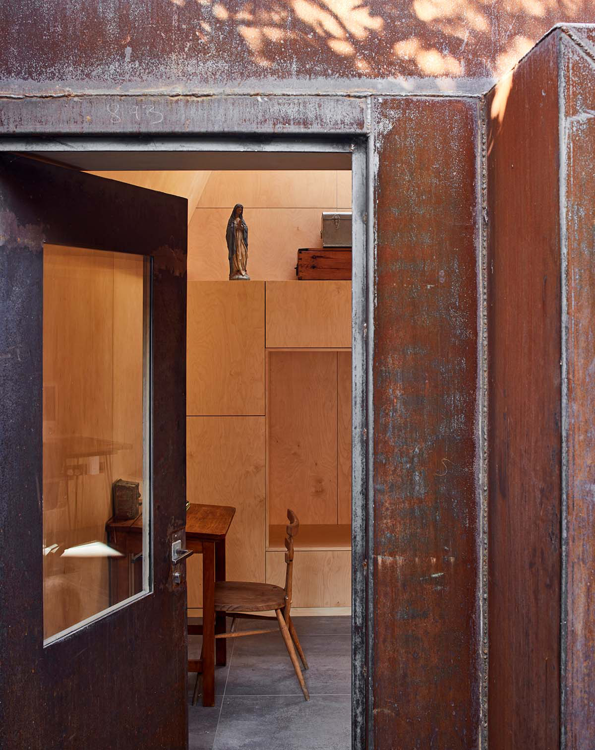 RISE Design Studio built sunken garden studio with rusted steel to provide a hidden place to escape