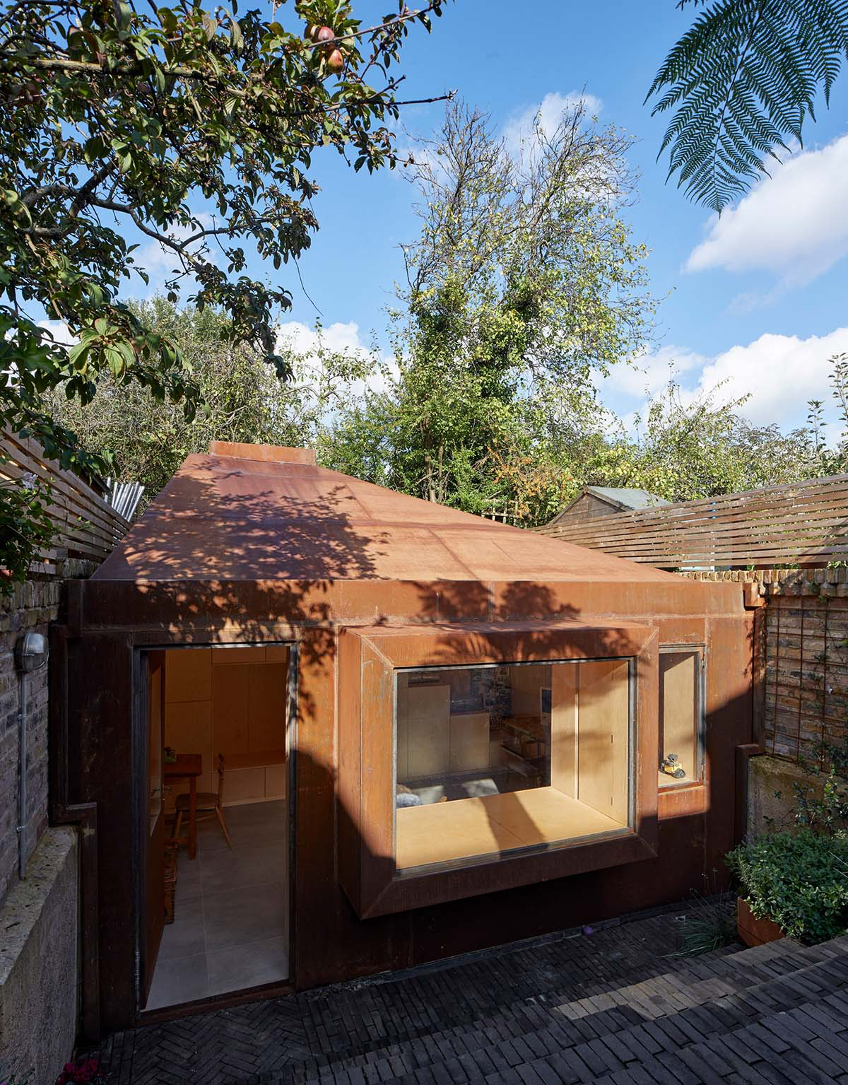RISE Design Studio built sunken garden studio with rusted steel to provide a hidden place to escape